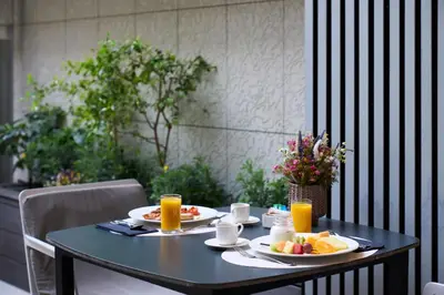 a table with plates of breakfast food on it at Catalonia Passeig de Gràcia 4* Sup in Barcelona