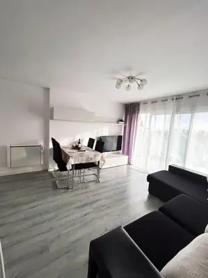 a living room with a couch and a table at Precioso apartamento en la playa Barcelona in Cabrera de Mar