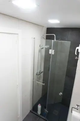 a shower with a glass door in a bathroom at Precioso apartamento en la playa Barcelona in Cabrera de Mar