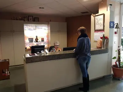 a woman standing at a counter in a restaurant at Hotel Don Pelayo in Arbós