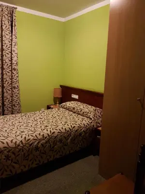 a small bedroom with a bed and a window at Hotel Don Pelayo in Arbós
