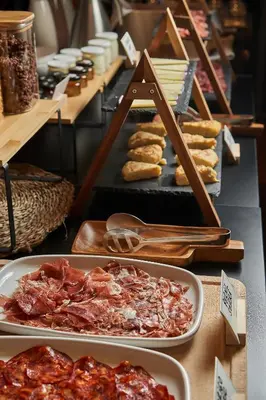 a buffet with plates of food on a table at Mercer Casa Torner i Güell in Vilafranca del Penedès