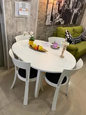 a white table and chairs with a bowl of fruit on it at BADAROSA House10min to BARCELONA City&NearTo BEACH in Badalona