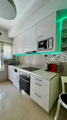 a kitchen with white cabinets and a stove top oven at BADAROSA House10min to BARCELONA City&NearTo BEACH in Badalona