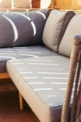 a couch with two pillows on top of it at Casa Felipa Plaza España in Barcelona