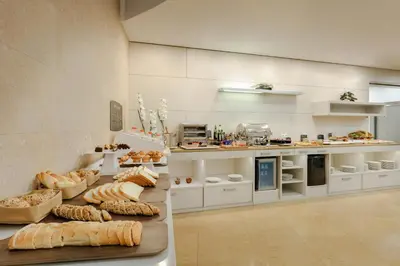 a kitchen with a bunch of breads on a counter at Catalonia La Boquería in Barcelona