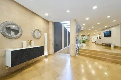 a lobby with a reception desk in a building at Catalonia La Boquería in Barcelona