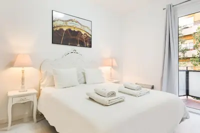 a bedroom with a white bed with towels on it at The White Flats Les Corts in Barcelona