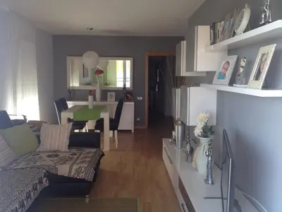 a living room with a couch and a table at Apartamento Primera Linea de Mar, Cunit in Cunit