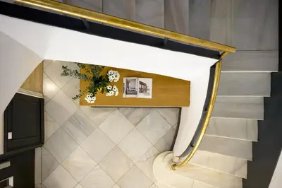 a staircase in a house with a gold rail at Casa Cosi - Eixample 2 in Barcelona