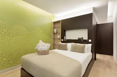 a bedroom with a large bed and a mirror at Ola Living Portaferrissa in Barcelona
