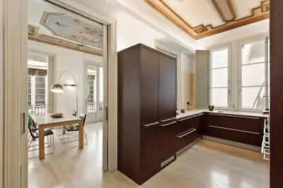 a dining room and kitchen with a table and a ceiling at Ola Living Portaferrissa in Barcelona