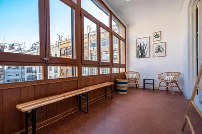 a waiting room with a bench and windows at eg21- MODERNIST AND ELEGANT APARTMENT IN BCN CITY CENTER in Barcelona
