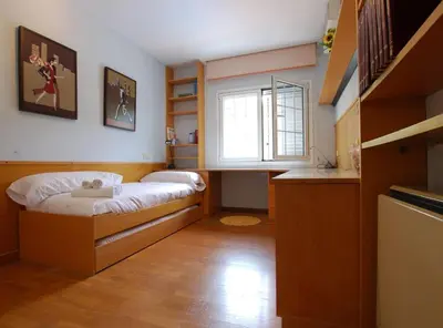 a small bedroom with a bed and a window at Villa Magnolia in Mataró
