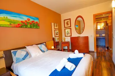 a bedroom with a large bed with towels on it at Megan Apartment by Hello Homes Sitges in Sitges
