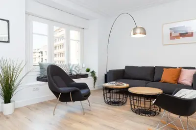 a living room with a couch and chairs and a table at Casa Cosi - Eixample 5 in Barcelona