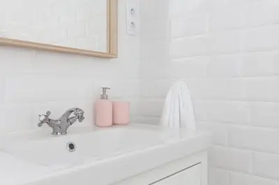 a white bathroom with a sink and a faucet at Casa Cosi - Eixample 5 in Barcelona