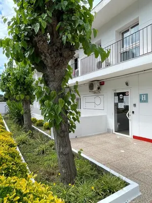 two trees in front of a building at Costa HP in Castelldefels