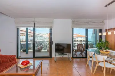 a living room with a couch and a table at HomeHolidaysRentals Escapade in Pineda de Mar