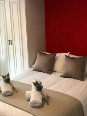 a bed with towels and flowers on top of it at Discover Sitges Center&Beach, a un minuto del mar in Sitges