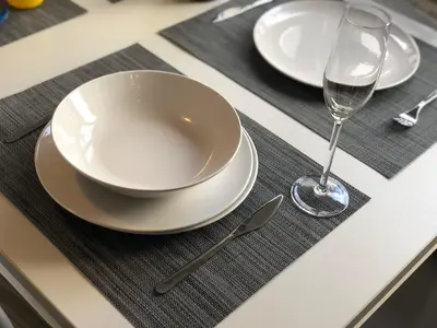 a table with two plates and a glass of wine at Discover Sitges Center&Beach, a un minuto del mar in Sitges