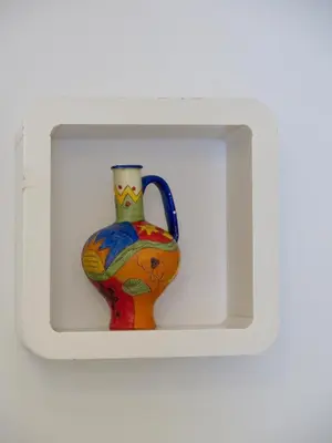 a colorful vase in a white box at Clot MiraBarna Apartments in Barcelona