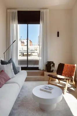 a living room with a couch and a table in front of a window at C211 Barcelona - Simaba Group in Barcelona