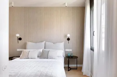 a bedroom with a large white bed and a window at C211 Barcelona - Simaba Group in Barcelona