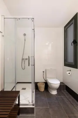 a bathroom with a toilet and a glass shower at C211 Barcelona - Simaba Group in Barcelona