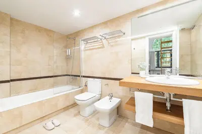 a bathroom with a toilet and a sink and a tub at Casa Bella Gracia by Aspasios in Barcelona