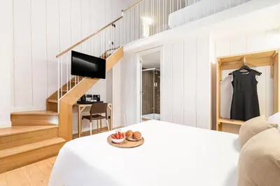 a living room with a bed and a staircase at Casa Bella Gracia by Aspasios in Barcelona