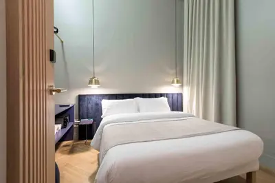 a bedroom with a bed and a walk in shower at BUHO Boutique Rooms in Barcelona