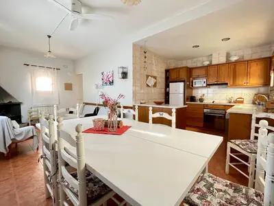 a kitchen with a large white table and chairs at El Porxo de Can Baixeres PB-00318 in Montseny