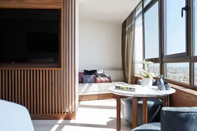 a room with a bed and a table and a window at Nobu Hotel Barcelona in Barcelona