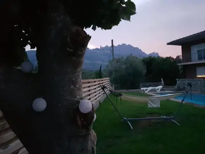 a hammock tied to a tree in a yard at Apartament Vall de Montserrat in Castellbell i Vilar