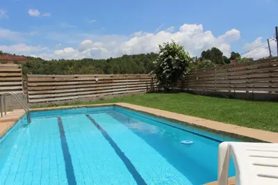 a swimming pool in a yard with a fence at Apartament Vall de Montserrat in Castellbell i Vilar