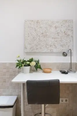 a white counter in a kitchen with a black chair at Hostal House in Barcelona