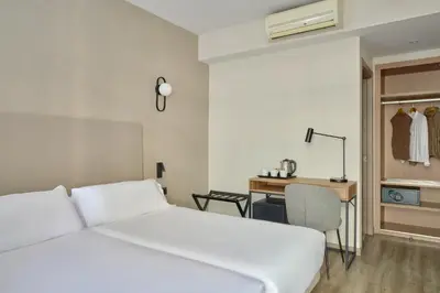 a bedroom with a white bed and a desk at Hostal Centric in Barcelona