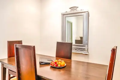 a table with a bowl of fruit in front of a mirror at Basic Platja in Barcelona
