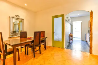 a dining room with a wooden table and chairs at Basic Platja in Barcelona