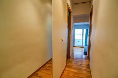 an empty hallway with a hallway leading into a room at Aire Apartment by Hello Homes Sitges in Sitges