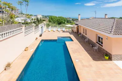 an image of a swimming pool on the roof of a house at HomeHolidaysRentals Aube in Sant Cebrià de Vallalta