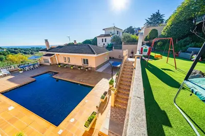 a house with a swimming pool in a yard at HomeHolidaysRentals Aube in Sant Cebrià de Vallalta