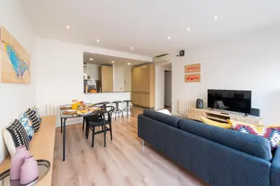 a living room with a blue couch and a table at Petit Luxe Tobella Baixos in Terrassa