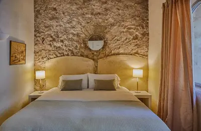 a bedroom with a large bed with two lamps at Casa Marqués at Masia Nur Sitges, Adults only in Canyelles