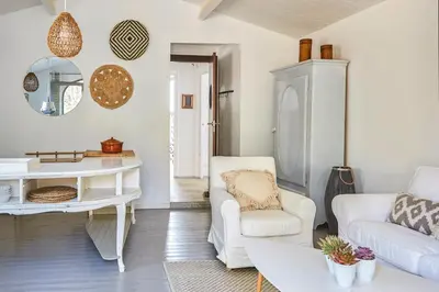 a living room with white furniture and a table at Casa Granada at Masia Nur Sitges, with private pool and adults only in Canyelles