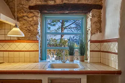 a kitchen with a sink and a window at Casa La Premsa at Masia Nur Sitges, Adults only in Canyelles