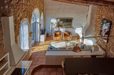 a living room with a couch and a table at Casa Azul at Masia Nur Sitges, Adults only in Canyelles