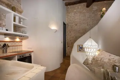 a living room with a staircase and a chandelier at Casa Olivo at Masia Nur Sitges, Adults only in Canyelles