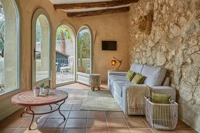 a living room with a couch and a table at Casa Olivo at Masia Nur Sitges, Adults only in Canyelles